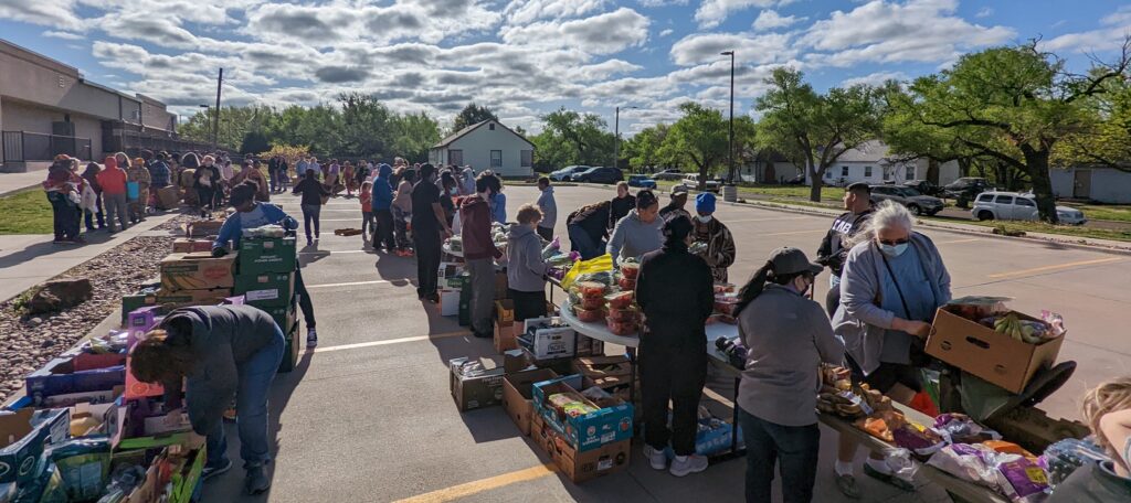 Image of hundreds of people lined up for a free produce giveaway at HealthCore Clinic in Wichita, Kansas.