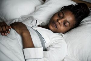 An African American woman sleeping soundly in bed