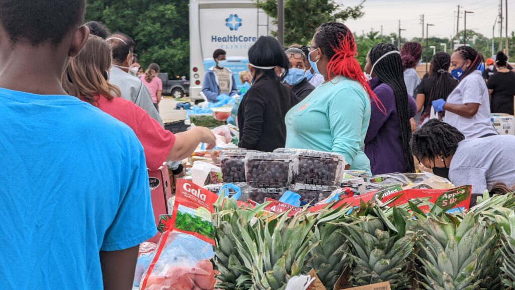 A crowd of people at a free produce giveaway at HealthCore Clinic in Wichita, Kansas