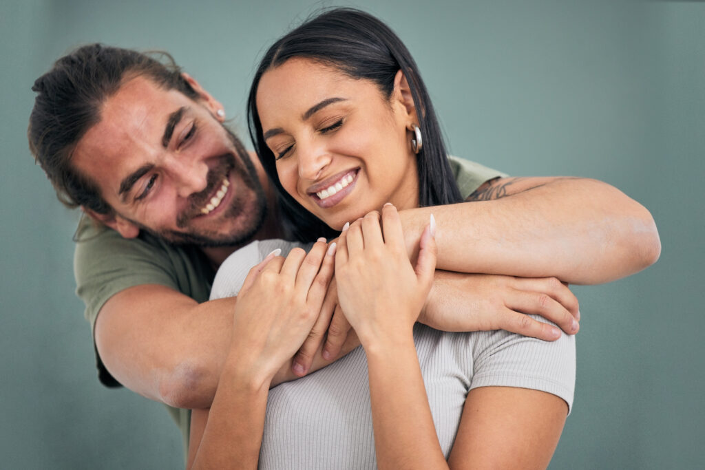 A man lovingly embraces his wife to show he supports her.